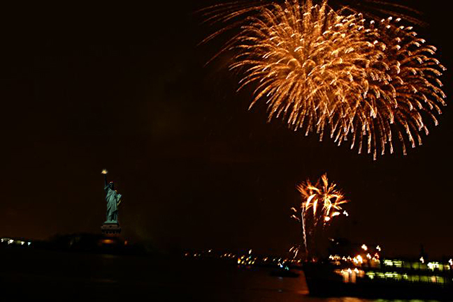 statue of liberty fireworks. Fire works over the Statue of