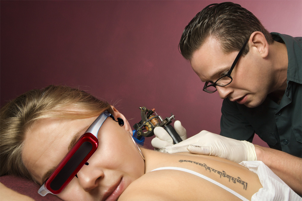 300 DPI photo of pain distraction with video glasses at the tattoo shop