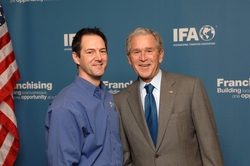 Upside Group Franchise Consulting President Mario Altiery with President George W. Bush at the Private VIP FranPAC reception during the 2010 IFA Convention