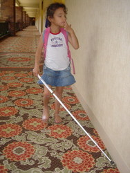 Exuding confidence with her white cane, Milagro walks to her hotel room at the National Federation of the Blind Convention