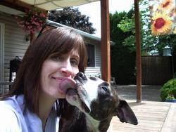 Lisa Sorensen with her dog in front of her home.