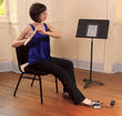 Flutist using an AirTurn footswitch to turn pages on an iPad