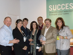 Third from left: J.D. Nespoli, Vice President of Merchandising, accepts an award for Relax The Back's humanitarian contributions.