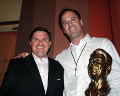 Harmon Kaslow holds the Ronald Reagan Award after accepting from Stewart McLaurin,