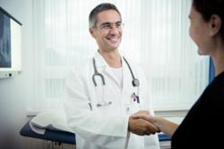 Cancer patient and oncologist shaking hands