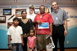 Mahavishnu Veerasingam and his family with Captain Tom Dyer (USA) and Ship Director Gian Walser (Switzerland) who presented him with gifts as the two millionth visitor to Logos Hope since her launch into ministry in February 2009. © OM Ships International