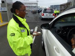 An attendant uses the WirelesssCarpark.com system to speed ingress at o.Co Coliseum.