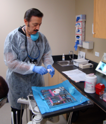 San Antonio cosmetic dentist Dr. Eddie Camacho, DDS, prepares for an extraction at the Smiles of Hope clinic.