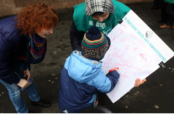 A child signs a pledge to live drug-free.