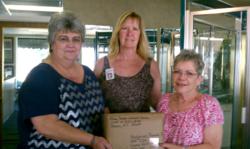 Glass Doctor of Central Carolina employees gather around their first pillow case shipment.