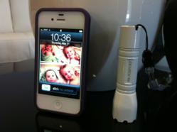 Rook SM2W White Flashlight next to an iPhone