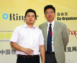 Microscan Applications Engineer Weijiang Song accepts the 2012 Ringier Technology Innovation Award for Microscan's new C-mount QX Hawk imager.