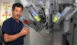 A Doctor in front of the da Vinci robot filming a medical segment