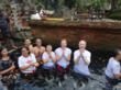 Guests on an Eat Pray Love tour of Bali experience the holy waters of Tirta Empul