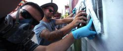 Toronto Muralists working with stencil painting a mural