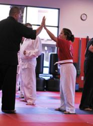 Instructor Bill Munger celebrating with a student at Sandoval Freestyle Karate