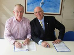Bluebird Care Managing Director, Paul Tarsey signing the contract with Stephen Flanagan, Managing Director of Bupa Home Healthcare.