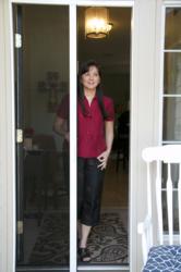 Photograph of Plisse II Retractale Door Screen in Use on Single, Entry Door