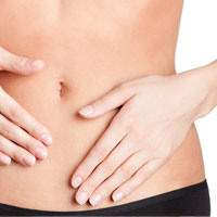 Woman touches her thin stomach with both of her hands