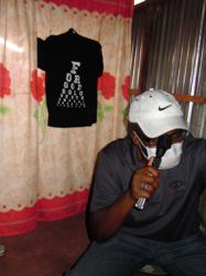 Dr. Derrick Artis, Vice President of Vendor Relations for Vision Source, uses an Eyes of Faith "John 3:16" eye chart tee during an eye exam in Kenya.