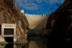 A photo of Hoover Dam taken in the morning light from the Colorado River.