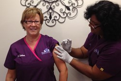 Dr. Marta Katalenas receives the flu shot at the Pediatric Center of Round Rock.