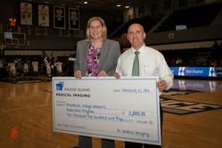 PC Women’s Basketball coach Susan Robinson Fruchtl accepts a $2,500 donation from Rhode Island Medical Imaging presented by Dr. Scott Levine.