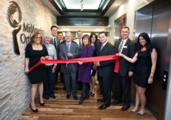 A ribbon cutting ceremony at MidAmerica Orthopaedics grand opening of its new Mokena clinic on Wednesday, April 10, 2013, Mokena, Ill. Center left to right, with scissors Gary Kronen, M.D., Gail Bastas Chamber Administrator of Mokena Chamber of Commerce,