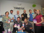 Conexus employees and piles of supplies.