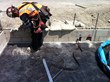 Courteny Waterproofing employee installing a termination bar at the edge of footing