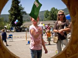 A child has perfect aim at the bean-bag-toss during last year's Open House and Carnival at the Children's Museum of the Sierra in Oakhurst. This year's event takes place June 15.