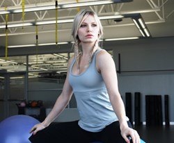 Beautiful girl wearing a dove grey athletic tank and black yoga pants.