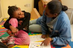 Michelle Morgan-Jackson reads with a patient at The Floating Hospital