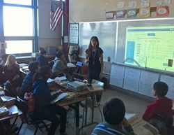 Teacher reviewing test results with group of middle school students using Terascore.