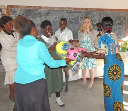 AWF's Lupani Conservation Primary School students and parents excitedly receive gifts of soccer balls and jump ropes from Chelsea Clinton of the Clinton Foundation. Credit: AWF