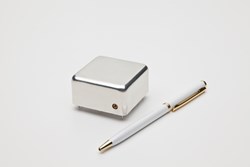 A Brandywine Communications Miniature GPS Disciplined Oscillator with a pen placed next to it to show scale