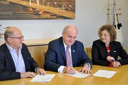 IU President Michael A. McRobbie signs a document