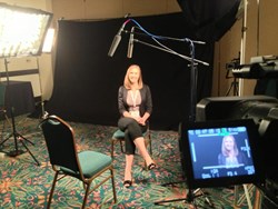 Aubrey Blankenship surrounded by cameras and lights.