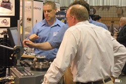 The busy exhibition floor provides opportunities to see new technology up close; above a booth demonstration at SPIE Optifab in 2011.