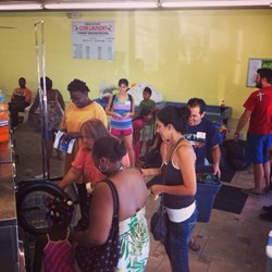 Full washing machines dominate the laundromat at a recent Laundry Project event where families were able to have their clothes washed for free.