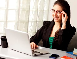 Woman wearing Phonetic Eyewear Alpha in Burgundy Crystal Fade in an office.