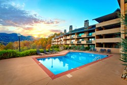 condo building with swimming pool and sunshine in the smokies