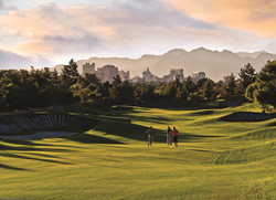 Las Vegas Golf Deal showing downtown Las Vegas from the perspective of golfers hitting balls on the fairway.