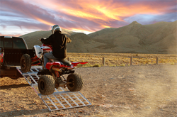 Quad rider safely driving up Shark Kae Multi-Use Truck Ramp