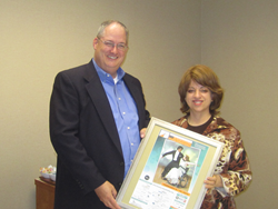 Rachel Davis, the Chief Development Officer at Jewish Family Services of Houston presented Monte Osburn, executive director of the Mostyn Moreno Foundation.