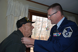 A Veteran is honored by a active duty member of the military.