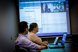 Classroom-based and remote students attend live classes together in a synchronous learning environment.