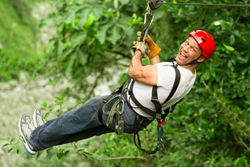man zip lining on Smoky Mountain vacation