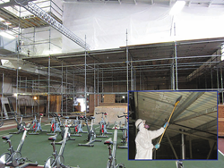 WCP safety suited worker prepares tiles for painting