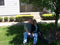 Bethanne Wasko with her boyfriend in front of the home she is fighting to save.